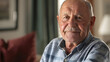 © john - Happy senior man looking at camera at home