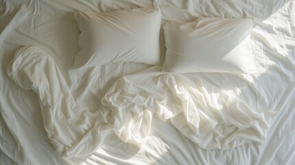 Wall Mural - a bed with a white comforter and two white pillows and a white comforter on top of the bed.