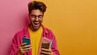 © Muhammad - Young hispanic student celebrating victory and happy good news online, man reading page interent received notification and message, hold phone, use app win and good achievement