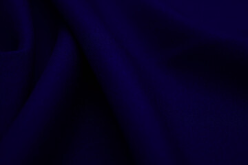 Texture of dark blue fabric closeup. Low key photo. Plexus threads. Clothing industry. Abstract background. Textile waves.