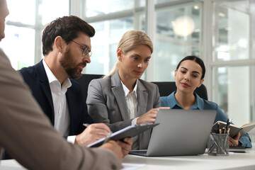 Canvas Print - Lawyers working together with laptop at table in office