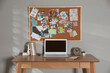 © New Africa - Stylish workplace with vision board and laptop