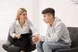 © New Africa - Psychologist working with teenage boy in office