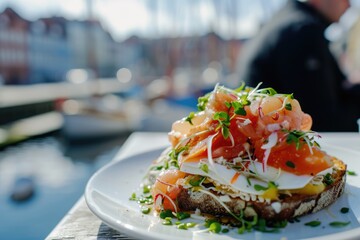 Canvas Print - Savoring Tradition: Chef Showcases the Delights of Smørrebrød Against the Picturesque Backdrop of Nyhavn Harbor in Copenhagen.