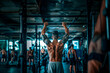 Back view of shirtless young man doing pull-ups in gym
