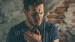 © Kinza - man pressing his chest with pain