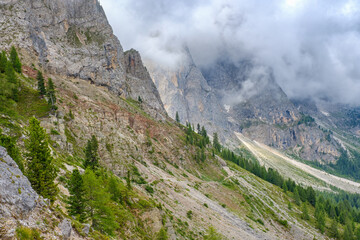 Wall Mural - Hiking trail on a slope in a extreme mountains terrain