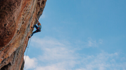 Wall Mural - rock climber girl. rock climber girl climbs an overhanging rock.