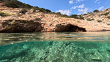 Fototapeta Na drzwi - Underwater split photo of paradise fjord rocky bay of Tourkopigado, Iraklia island, small Cyclades, Greece