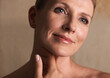 © Duncan M/peopleimages.com - Woman, mature and proud with skincare, treatment and cosmetic for confidence. Senior, tile and smile with natural glow, satisfaction and elegance with happiness and self care in bathroom or home