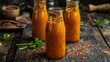 Carrot juice with flax seeds in glass bottles.
