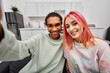 © LIGHTFIELD STUDIOS - joyous appealing multicultural couple in casual attire taking selfies and smiling at camera