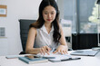 © NINENII - lifestyle of office workers Woman calculating expenses and using laptop. Home office. Work place. Lifestyle.