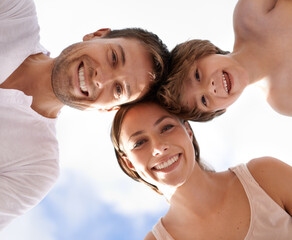 Summer, sky and low angle of family in portrait with love, care and support child with happiness. Holiday, travel or kid with parents on vacation in Florida and smile from below with mom and dad