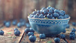 Fresh blueberry bowl on a wooden background.