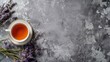 captivating fresh lavender tea with lavender flowers on a gray stone table, offering a delicious and aromatic drink for relaxation against a serene background
