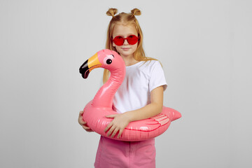 Wall Mural - Redhead teen girl with flamingo pool float toy wearing glasses. Summer, vacation