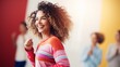 Radiant woman with voluminous curly hair, striped vibrant outfit, joyous expression, blurred background, energy, happiness.