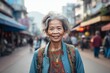 Happy elderly asian woman smiling positively with blurred street background in macro view