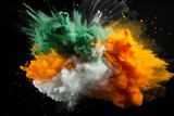 Fototapeta  - Colored powder explosion. Green, white and orange colors dust on black background. Multicolored powder splash background
