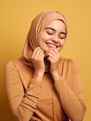 Wall Mural - happy smiling young muslim woman wearing traditional headscraf. portrait, studio shot