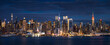 New York City panoramic view at dusk from the Hudson River. The view includes the skyscrapers of Manhattan Midtown West Manhattan illuminated at night. NYC, NY, USA