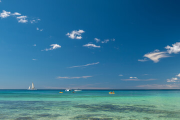 Seascape with crystal clear turquoise water, yachts, boats and people kayaking. South destination, vacation concept.