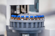 © Paul Reverve - Close up of science experiment Vials filled inside an autosampler of an HPLC machine in a Science experiment laboratory for research analysis and clinical trial study