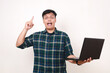 © ArvStd - Happy young asian college student getting a good idea while holding a laptop