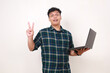 © ArvStd - Young asian college student showing two fingers while holding a laptop