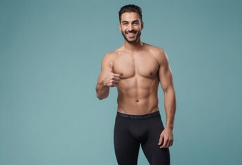Wall Mural - A muscular man in athletic wear gives a thumbs up. His fit body and cheerful expression promote a healthy, active lifestyle.
