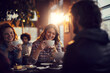 © Marko Geber - Young people at a cafe enjoying coffee and talking together