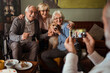 © Davor - Group of seniors with dog taking a photo together