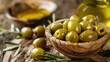 Green marinated olives, olive oil on a wooden table 