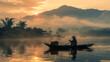 A peaceful scene with a boatman on a river during sunrise amidst the foggy mountains and traditional houses