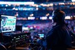 Sports broadcast technician operating equipment at a crowded stadium event.