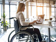 © Orkidia - A person with a motor disability working in an inclusive workplace