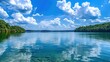 Panoramic landscape photo for a website featuring a clear blue sky over a serene lake on a beautiful summer day.