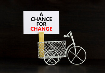 A chance for change symbol. Concept words A chance for change on beautiful white paper on clothespin. Bicycle model. Beautiful black background. Business A chance for change concept. Copy space.