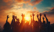 Crowd of people with their hands up for adoration and praise at sunset, worship concept 