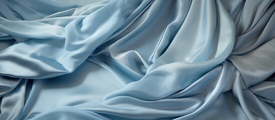 Poster - This close-up view showcases a light blue silk cloth with soft folds and highlights, creating a serene and elegant backdrop.