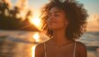 Portrait of beautiful happy young african american woman with afro hairstyle on the beach at sunset