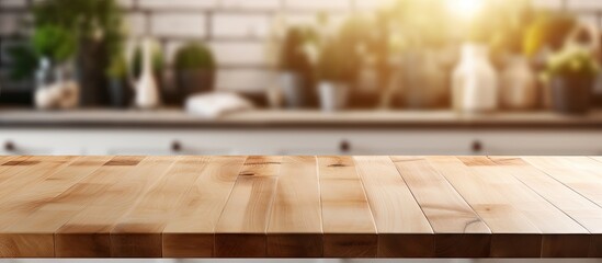 Canvas Print - A wooden table stands in the foreground, set against a blurred kitchen interior in Scandinavian style. The natural lighting creates a warm ambiance, making it ideal for product display or mockup