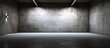 An empty room with two lights affixed to the masonry wall, casting a bright glow in the dark space with white and black concrete floors. The lights create a stark contrast against the minimalist