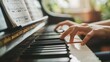 A detailed shot of a students hands as they carefully play a piano in a conservatory practice room their fingers expertly striking the keys with precision and grace. Sheet