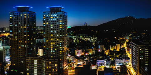 Wall Mural - Seoul City Downtown Night Skyline with glowing modern skyscrapers, buildings, traditional houses, lighted Namsan Tower, and Namsan Mountain National Park in South Korea