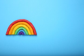 Wall Mural - Beautiful rainbow made of plasticine on light blue background, top view. Space for text