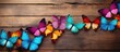 Multiple decorative butterflies of varying colors are seen perched on a wooden surface. The vibrant colors of the butterflies contrast beautifully with the natural wood texture.