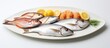 A white plate holding fresh fish fillets topped with lemon wedges, ready to be cooked or served for a delicious meal. The vibrant colors of the fish and lemon contrast beautifully against the clean