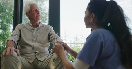 Canvas Print - Wheelchair, nurse and comfort elderly man over mobility, clinic rehabilitation or health disease. Communication, nursing home and caregiver of sick patient with disability, depression or injury risk